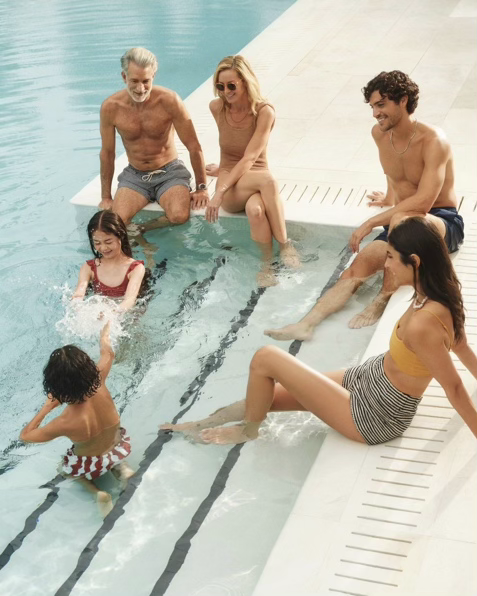 Family relaxing by the pool