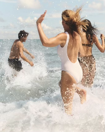 Guests running into the ocean